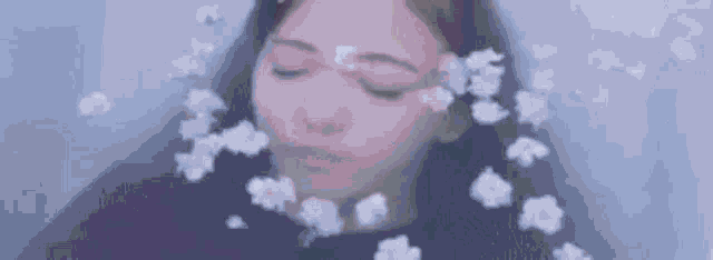 a close up of a woman 's face in a bathtub with water coming out of her mouth .