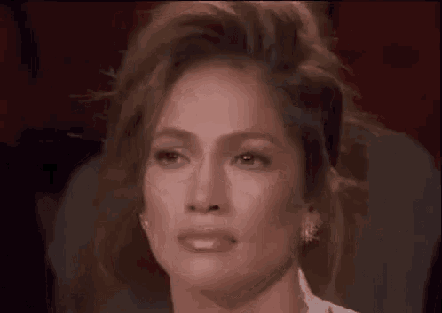 a close up of a woman 's face with a caption in a foreign language .