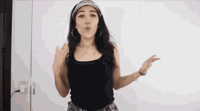 a woman wearing a headband and a black tank top