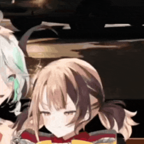 a couple of anime girls are sitting next to each other on a table in a dark room .