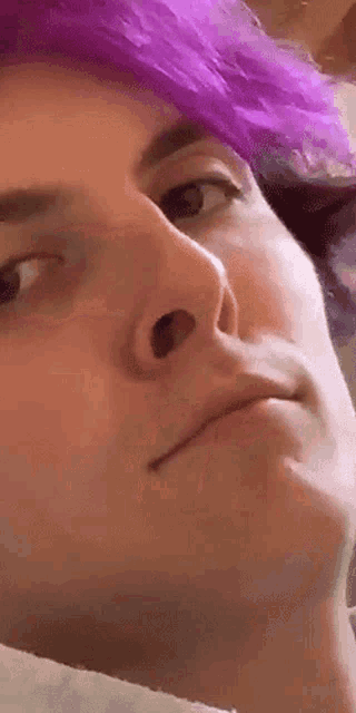 a close up of a person with purple hair