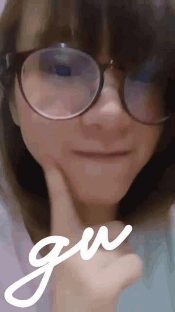 a woman wearing glasses is making a funny face and the word gw is next to her