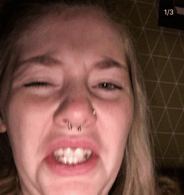 a close up of a woman 's face with the number 1/3 visible in the corner