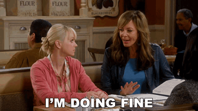 two women sit at a table with the words i 'm doing fine written below them