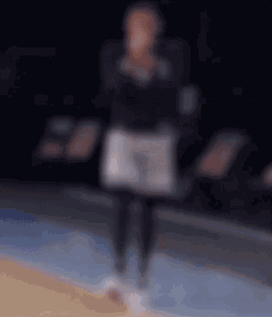 a blurred image of a person standing on a basketball court