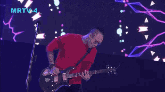 a band performs on a stage with a sign that says mrtv-4 on it