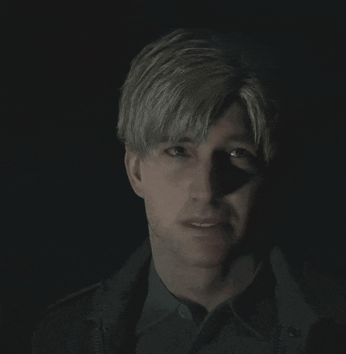 a man with blonde hair looks at the camera