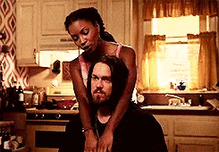 a man and a woman are sitting in a kitchen .