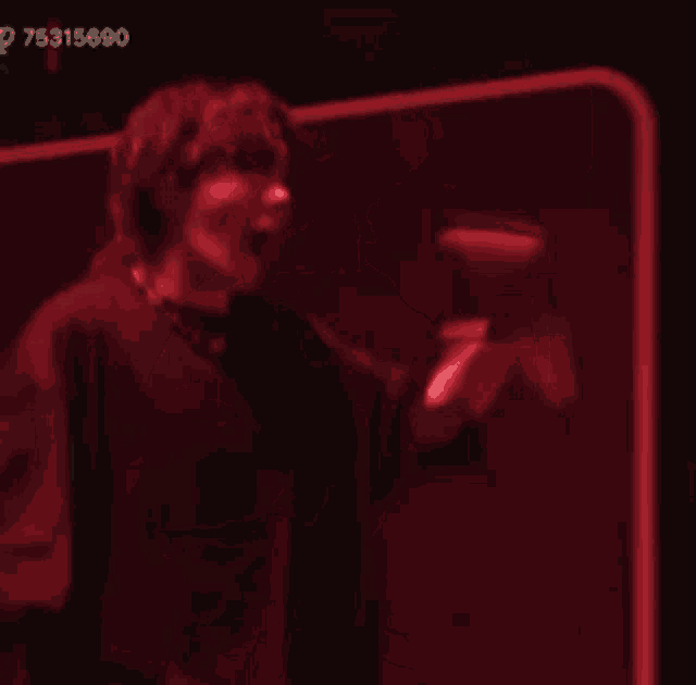 a blurred image of a phone booth with the number 75315690 on the bottom