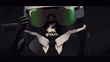 a man in a suit and tie is wearing a pair of sunglasses that say stan