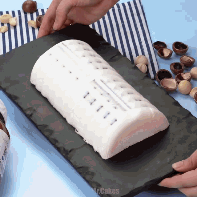 a person is holding a piece of cake that says mr. cakes on it