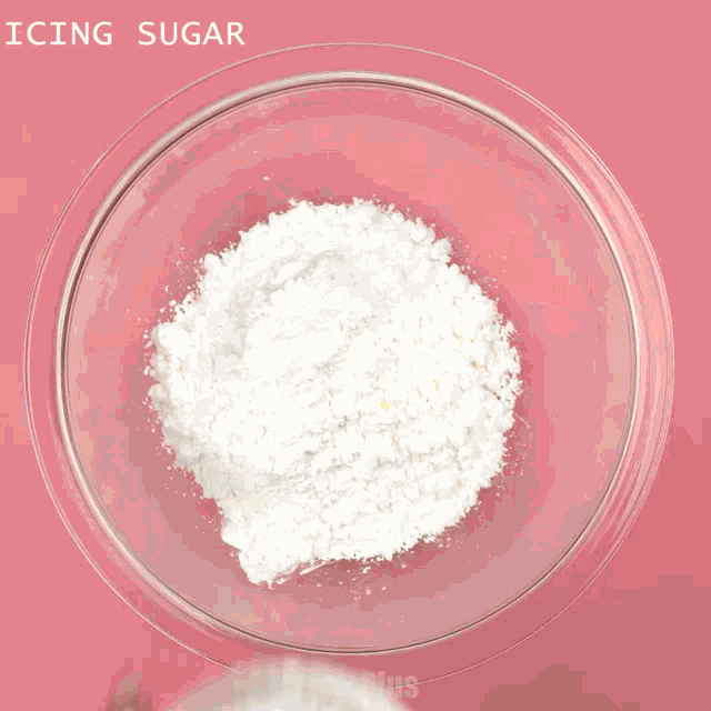 a person is mixing icing sugar in a bowl