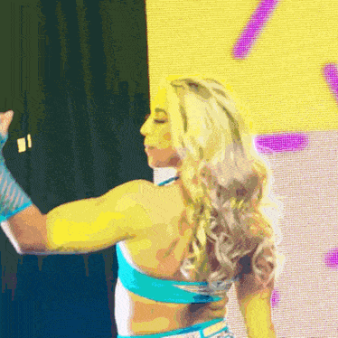 a woman in a blue top and shorts is dancing