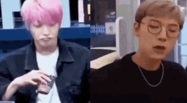 a man with pink hair and glasses is making a face next to a man with black hair and glasses .