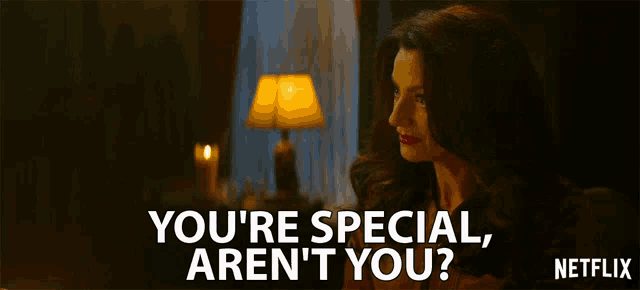 a woman is sitting in front of a lamp and says " you 're special aren 't you ? "