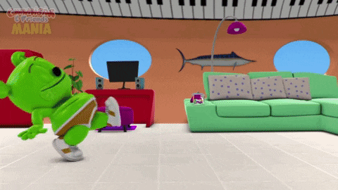 a gummy bear is dancing in a living room with the words gummy bears mania written on the ceiling