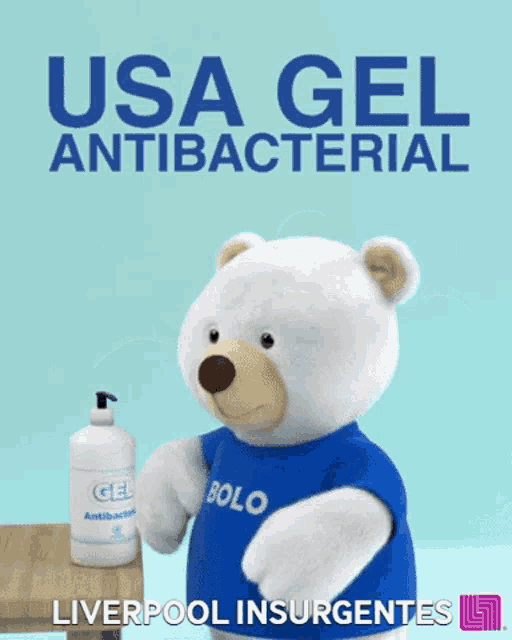 a teddy bear wearing a bolo shirt is holding a bottle of usa gel