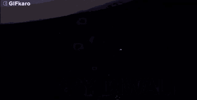 a fireworks display in the night sky with a gifkaro logo in the corner
