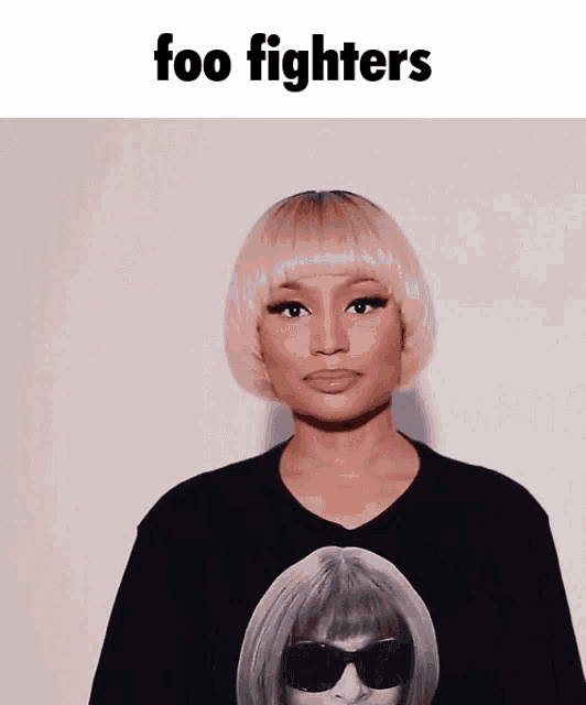 a woman wearing a black shirt with a picture of a woman and the words foo fighters
