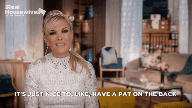 a woman says it 's just nice to like have a pat on the back in a living room