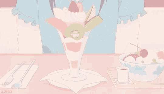 a girl is sitting at a table eating a fruit parfait with a fork .