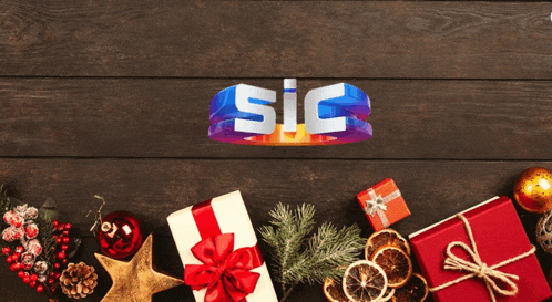 a wooden table with christmas presents and decorations and the word sic on top