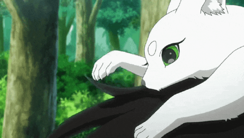a white cat with green eyes is sitting on top of a black bird .