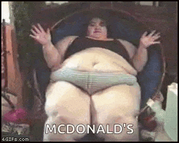 a very fat woman is sitting in a chair with her arms outstretched and says `` mcdonald 's '' .