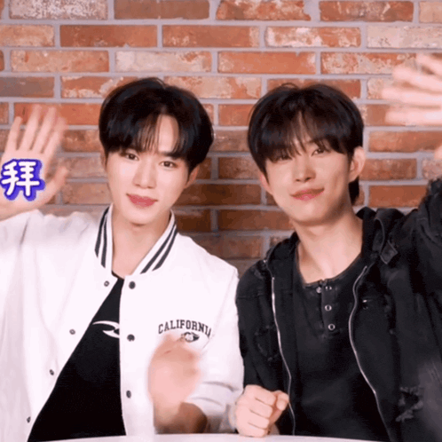 two young men standing next to each other one wearing a jacket that says california