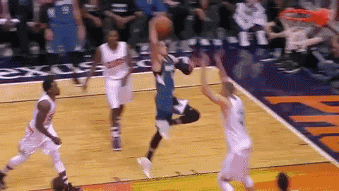 a basketball game is being played in front of a sign that says ' exes ' on it