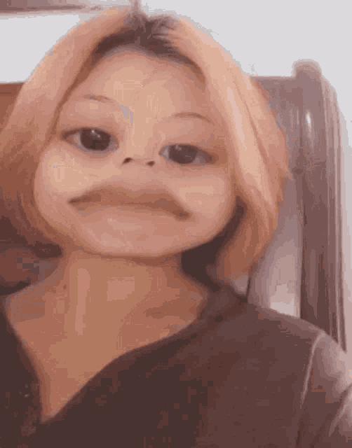 a woman with a fake mustache is making a funny face .
