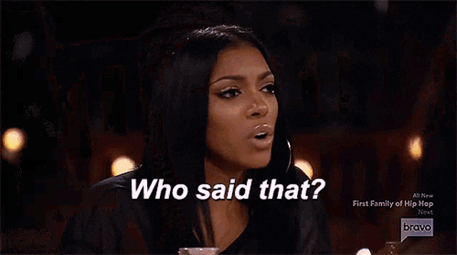 two women are sitting at a table and one of them is saying who said that