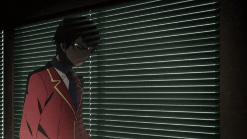 a man in a red suit is covering his mouth with his hand