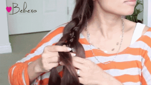 a woman is braiding her hair in front of a bebexo logo