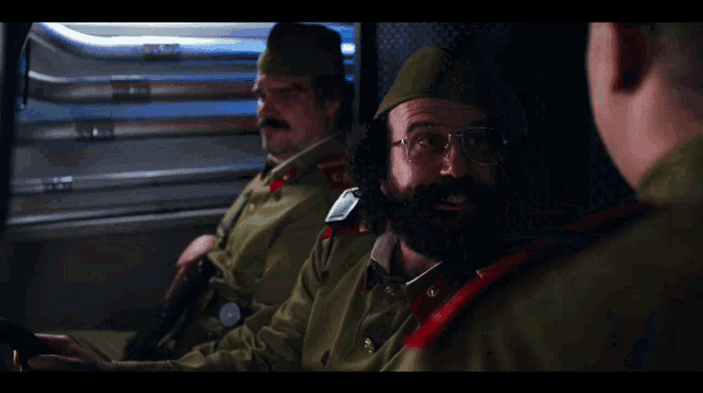 a man with glasses and a beard is wearing a uniform that says ca