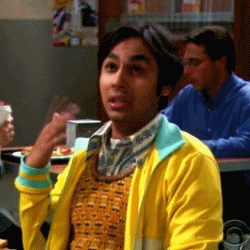 a man in a yellow jacket is sitting at a table in a restaurant