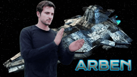 a man stands in front of a space ship with the name arben on the bottom