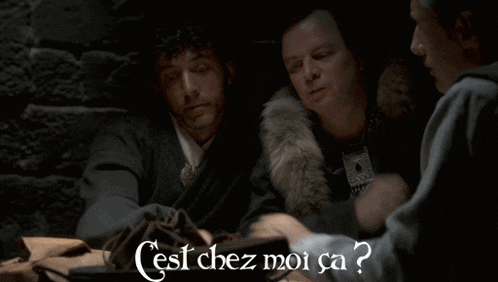 two men are sitting next to each other with the words cest chez moi ca written on the bottom