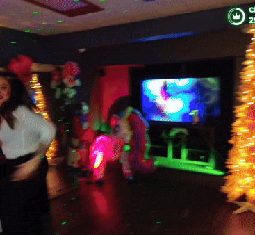 a woman dancing in a room with a sign that says cl 24