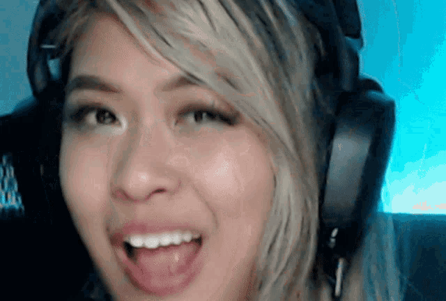 a woman wearing headphones with her tongue hanging out