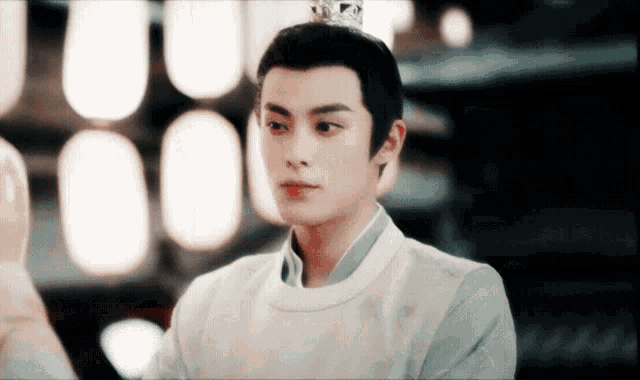 a young man with a crown on his head