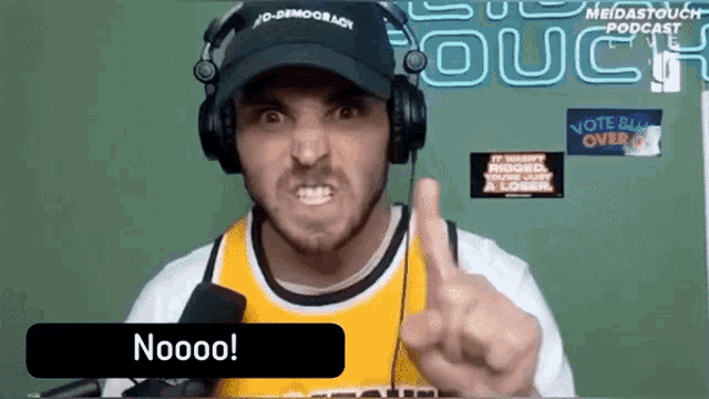a man wearing headphones and a hat with no democracy written on it