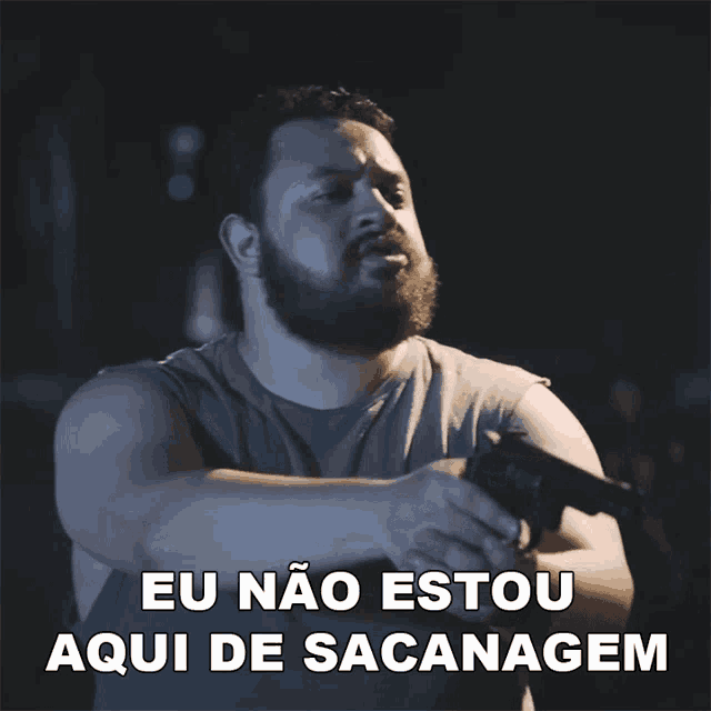 a man holding a gun with the words eu nao estou aqui de sacanagem behind him