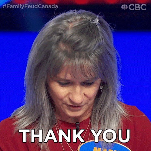 a woman with gray hair is giving a thank you gesture