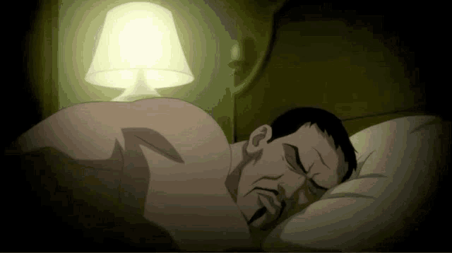 a man without a shirt is sleeping in a bed with a lamp behind him