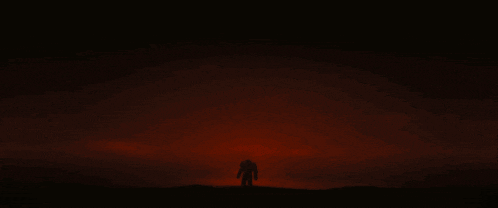 a person standing in front of a large sun