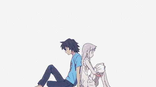 a boy and a girl are sitting next to each other on the ground .