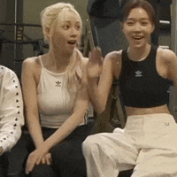 three women are sitting next to each other in a room .