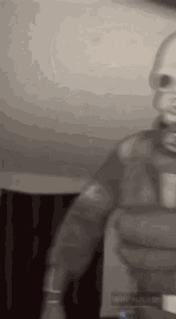 a blurry picture of a person holding a bottle of wine in their hand .