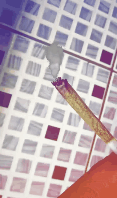 a close up of a cigarette with smoke coming out of it